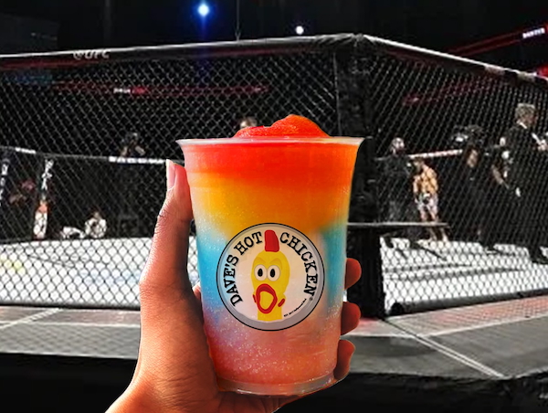 Hand holding a colorful layered 3-Round Slusher drink from Dave’s Hot Chicken in front of a UFC octagon during a live fight event, highlighting the Dave’s Hot Chicken x UFC partnership and limited-time beverage.